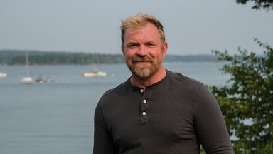 Graham Platner stands in front of the ocean