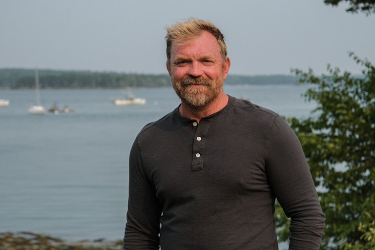 Graham Platner stands in front of the ocean
