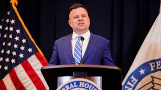 Bill Pulte speaks at a podium
