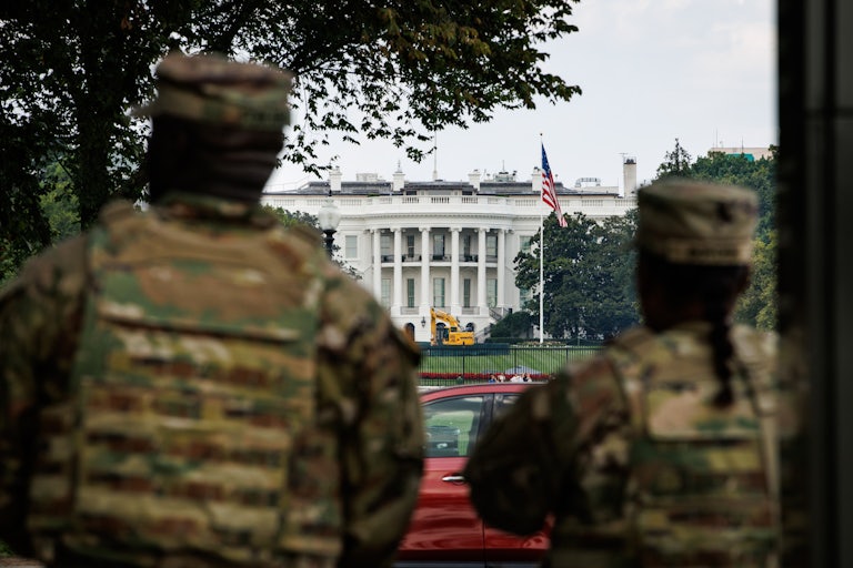 Two members of the D.C. National Guard stand in front of the White House in Washington D.C.