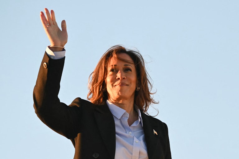 Kamala Harris waves while boarding Air Force Two