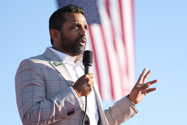 Kash Patel gestures and speaks into a microphone