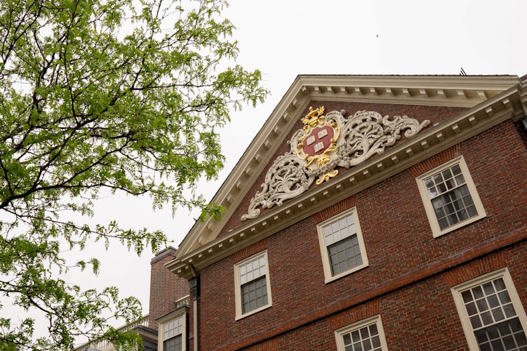 The Harvard University seal on a building on the school campus
