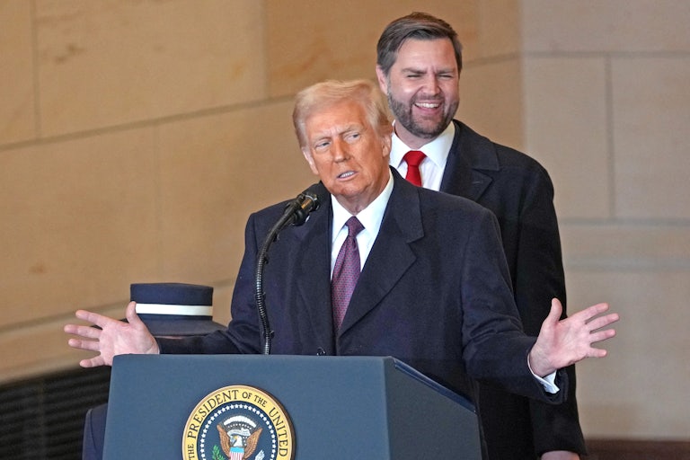 Donald Trump gestures while speaking at a podium after his inauguration
