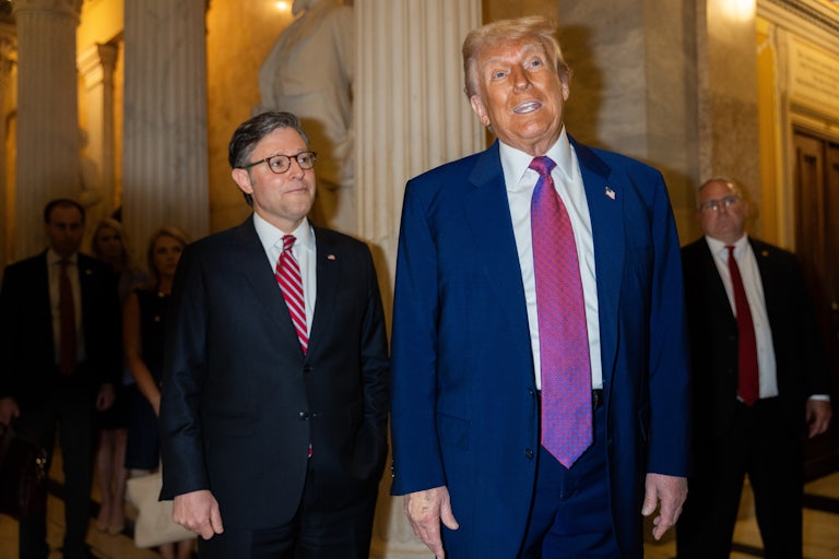 Donald Trump stands next to House Speaker Mike Johnson and speaks to reporters in the U.S. Capitol