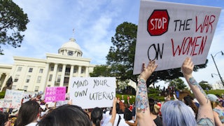 Demonstrators participate in a 2019 rally against restrictive bans on abortions outside the Alabama statehouse.
