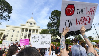 Demonstrators participate in a 2019 rally against restrictive bans on abortions outside the Alabama statehouse.