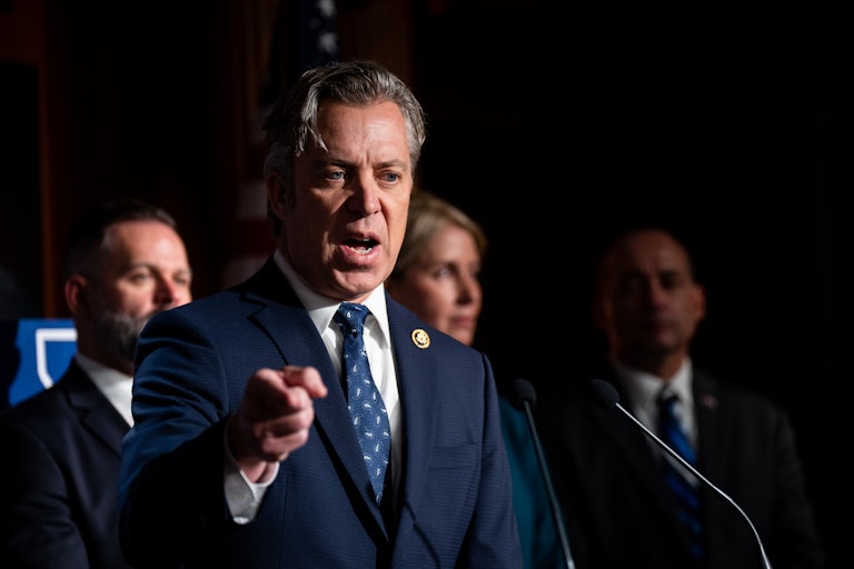 Representative Andy Ogles yells and points a finger