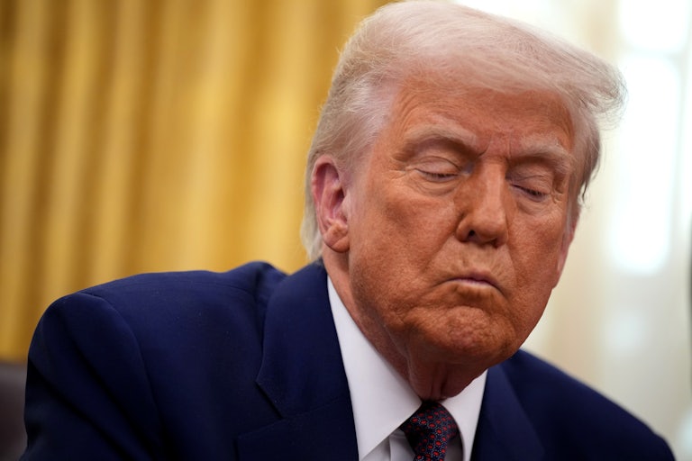 Donald Trump frowns during a press conference in the Oval Office