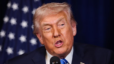 Donald Trump speaks into a microphone