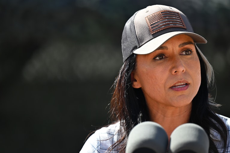 Tulsi Gabbard speaks into microphones during a visit to the U.S.-Mexico border