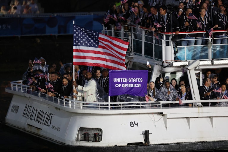 Lebron James is seen waving the U.S. flag on a boat with team mates along the River Seine during the opening ceremony of the Olympic Games Paris 2024 on July 26, 2024 in Paris, France.