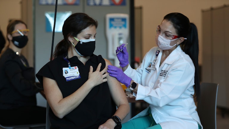 A woman in Florida is vaccinated in December 2020.
