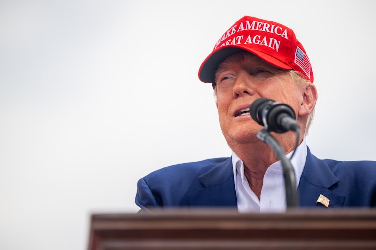 Donald Trump speaks into a microphone