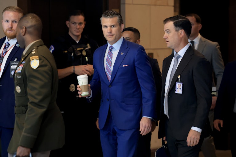 Defense Secretary Pete Hegseth exits a meeting with senators about Iran.
