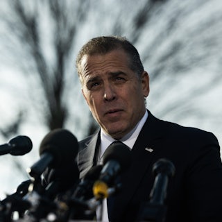 Hunter Biden speaks outside at a lecturn with several mics