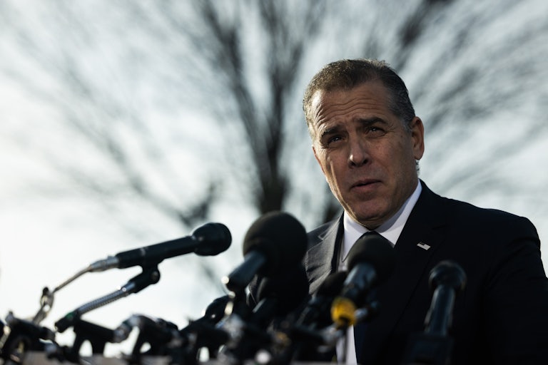 Hunter Biden speaks outside at a lecturn with several mics