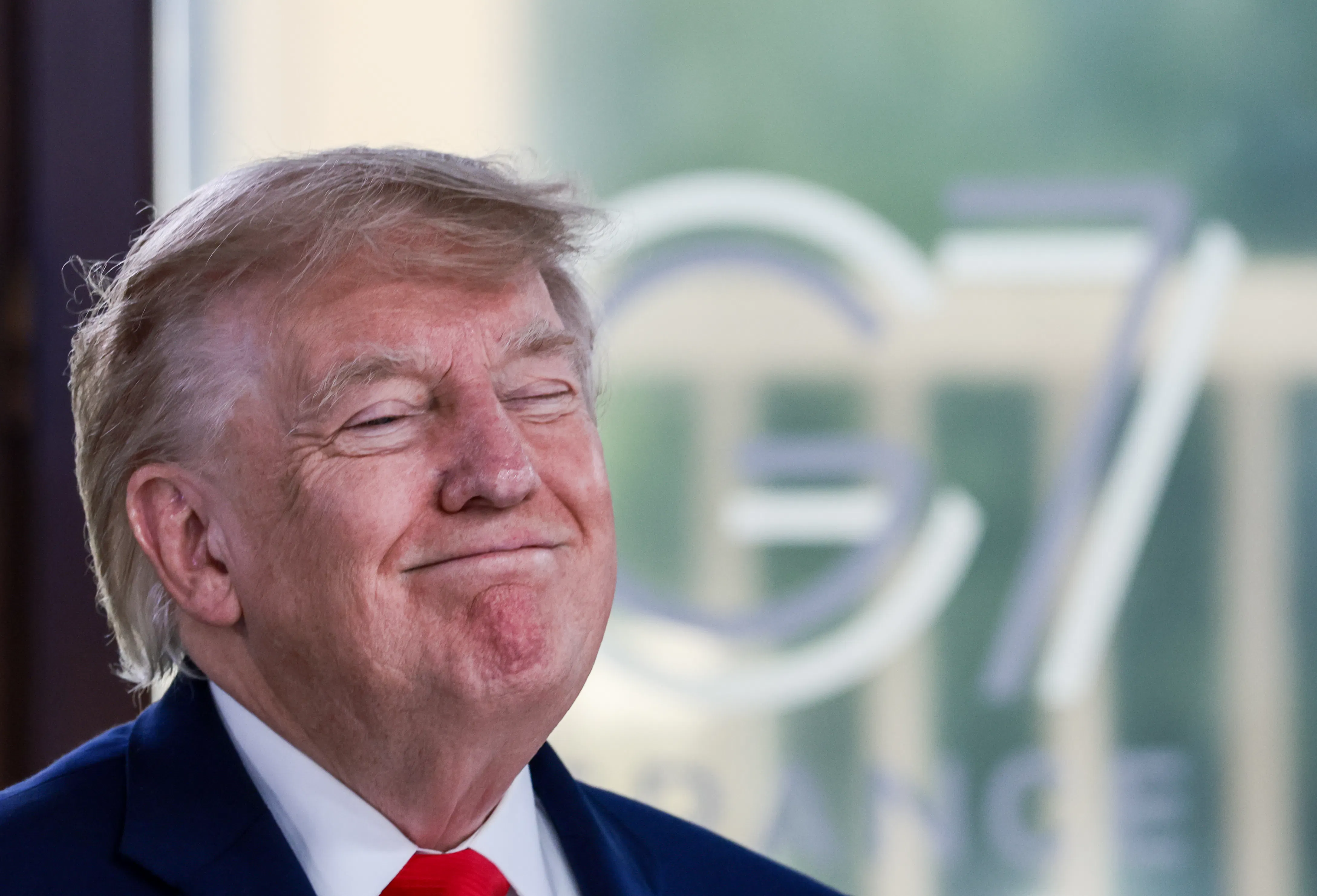 Donald Trump grins with eyes shut