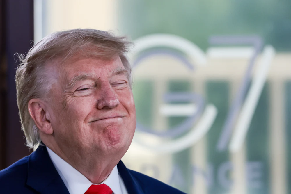 Donald Trump grins with eyes shut