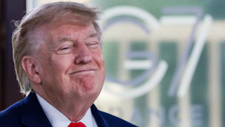 Donald Trump grins with eyes shut