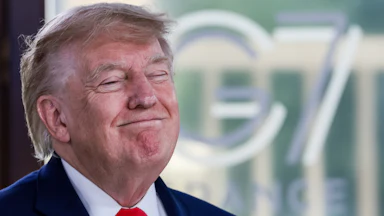 Donald Trump grins with eyes shut