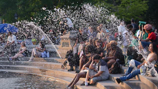 People spend time at Washington Square Park in New York City
