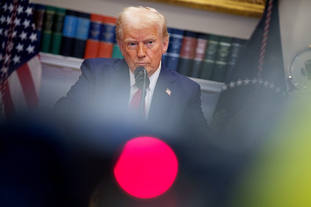 Donald Trump takes a question from a reporter during a news conference in the Roosevelt Room of the White House.