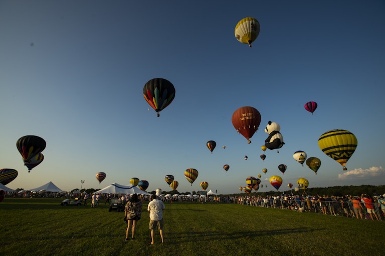 Hot air balloons rise over a field in Readington, NJ.