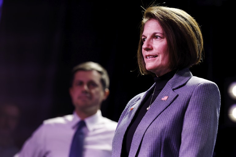 Profile view of Cortez Masto, as she smiles on stage.