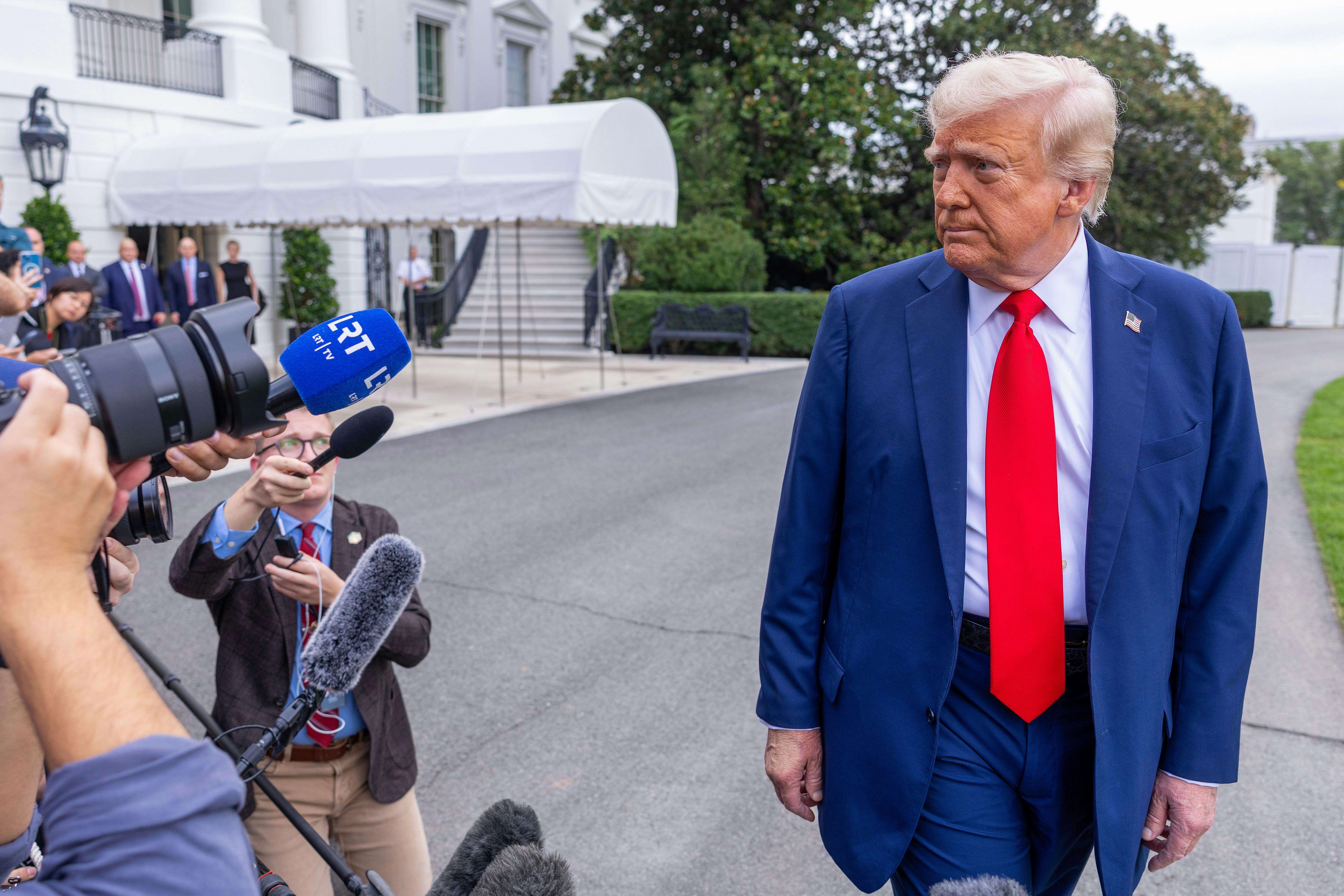Donald Trump talks to the media before boarding Marine One on the South Lawn of the White House.