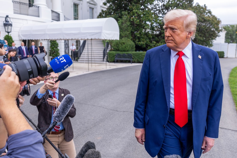Donald Trump talks to the media before boarding Marine One on the South Lawn of the White House.