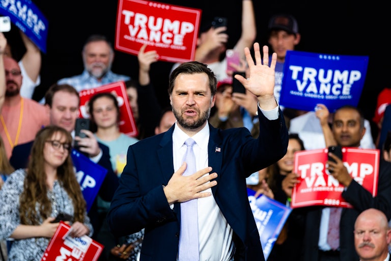 J.D. Vance waves at a Donald Trump rally