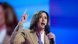 Kamala Harris speaks while holding up a finger.