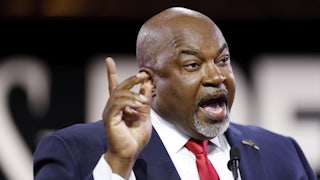 Mark Robinson speaks with finger raised in the air