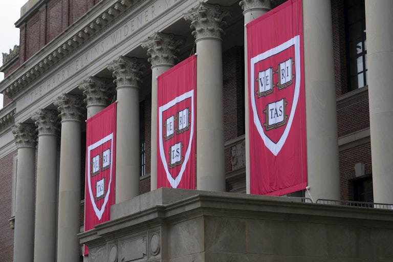 Banners with the Harvard crest hang on the front of the university library