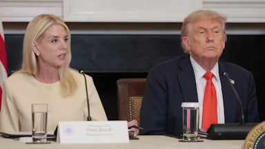 Attorney General Pam Bondi sits next to Donald Trump on a panel.