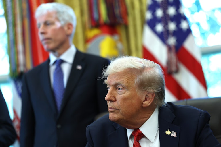 Donald Trump sits at his desk in the Oval Office, while Energy Secretary Chris Wright stands behind him