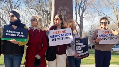 Protesters hold signs that read "Abortion is Health Care," "Defend Medication Abortion, Bigger than Roe," and "Not Your Uterus Not Your Decision."