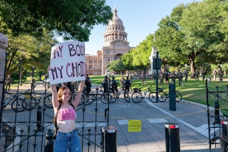 A pro-reproductive rights protester stands outside the Texas Supreme Court