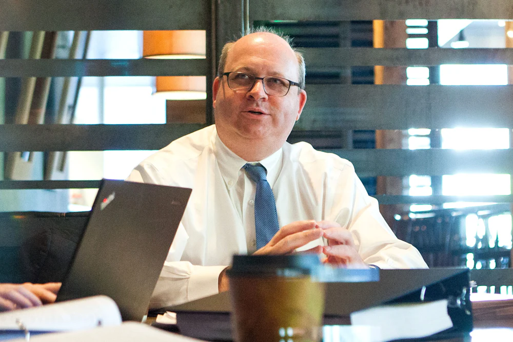 Mark Elias photographed talking while seated in an office