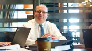 Mark Elias photographed talking while seated in an office