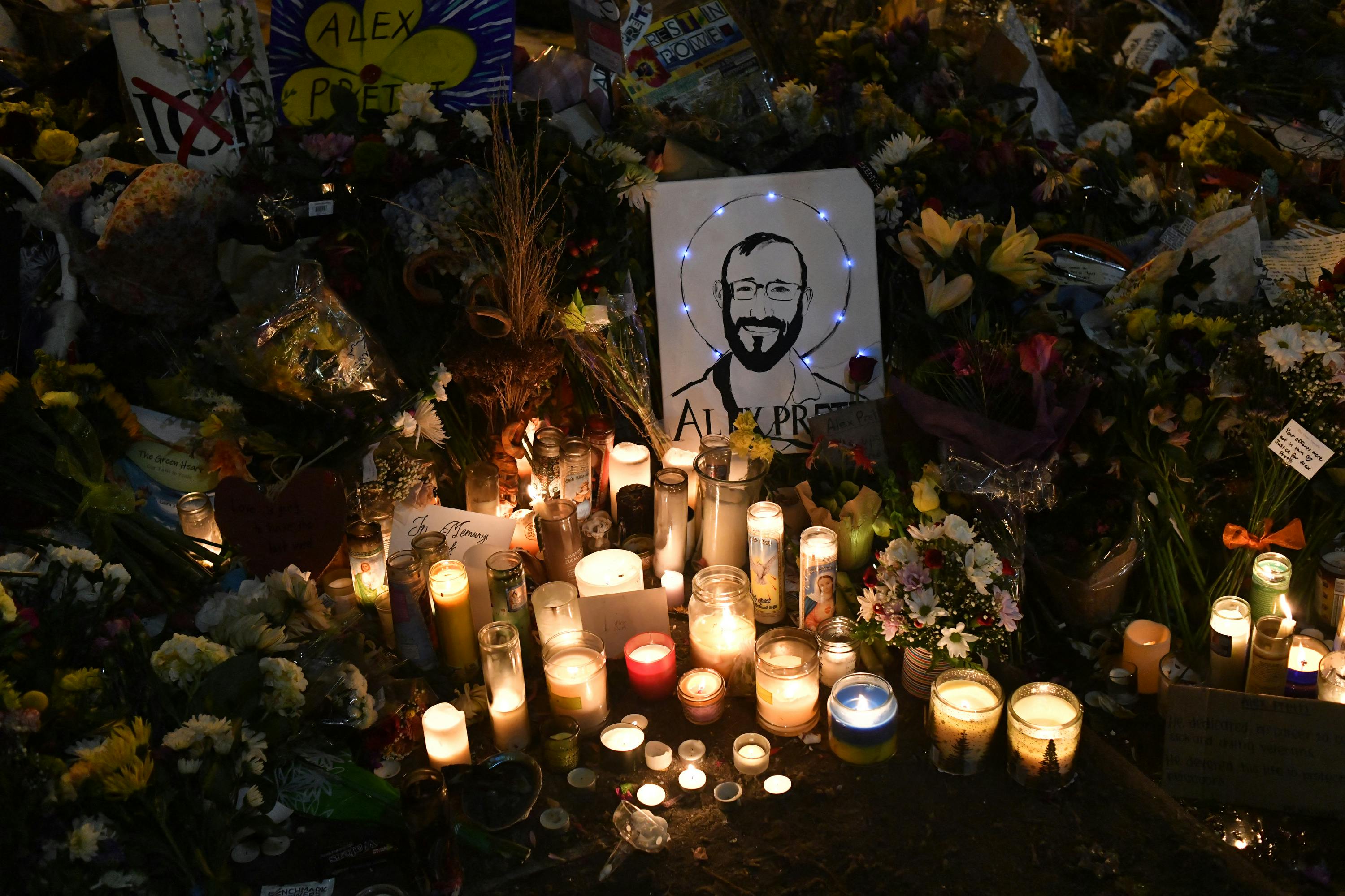 A drawing depicting Alex Pretti is displayed along candles at a makeshift memorial in his honor in the area where he was shot dead by federal immigration agents in Minneapolis, Minnesota.