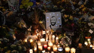 A drawing depicting Alex Pretti is displayed along candles at a makeshift memorial in his honor in the area where he was shot dead by federal immigration agents in Minneapolis, Minnesota.