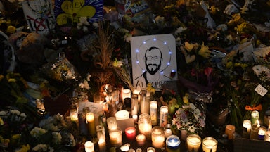 A drawing depicting Alex Pretti is displayed along candles at a makeshift memorial in his honor in the area where he was shot dead by federal immigration agents in Minneapolis, Minnesota.