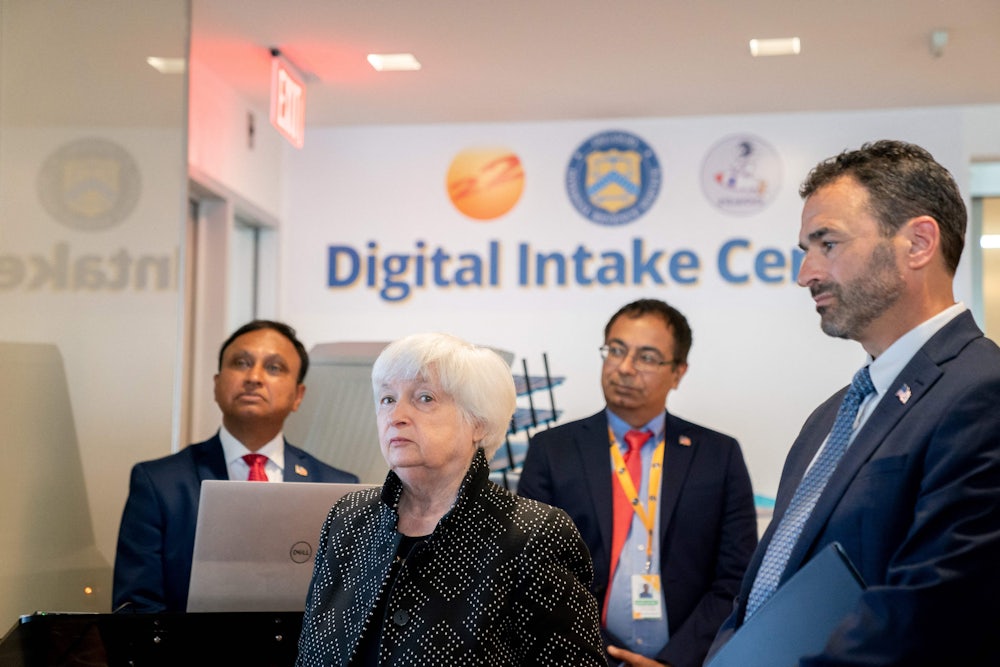 Yellen, Werfel, and two others stand in front of a wall reading "Digital Intake Center."