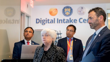 Yellen, Werfel, and two others stand in front of a wall reading "Digital Intake Center."