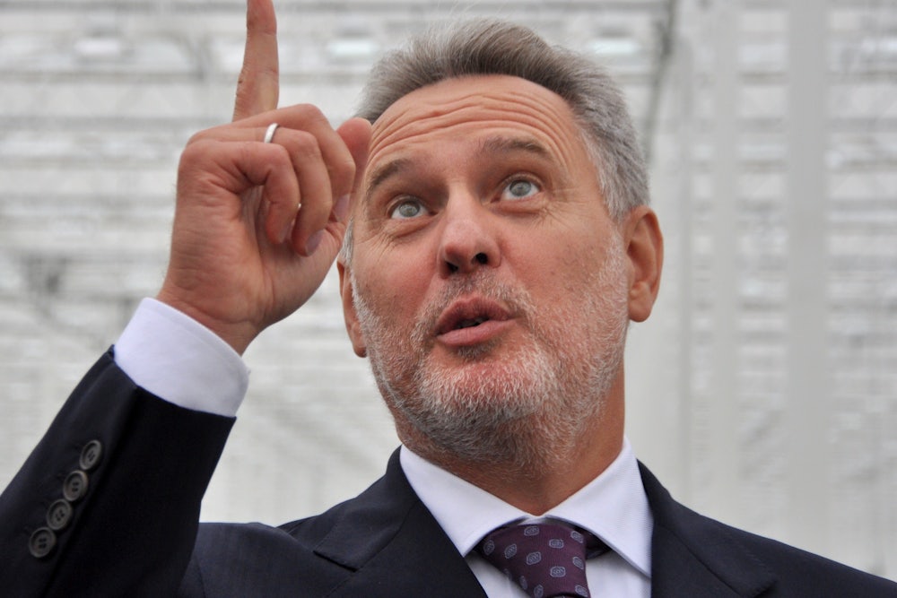 Ukrainian oligarch Dmitro Firtash points upward.