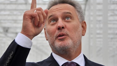 Ukrainian oligarch Dmitro Firtash points upward.
