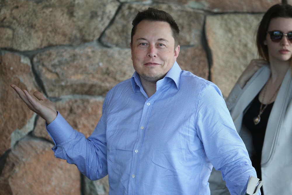 Tesla CEO Elon Musk shrugs his shoulders with a bemused expression on his face