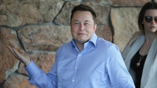 Tesla CEO Elon Musk shrugs his shoulders with a bemused expression on his face